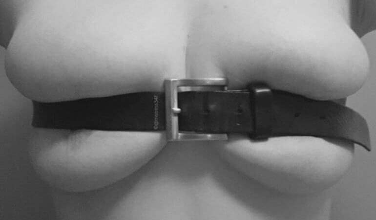 Missy's breasts bound with a belt