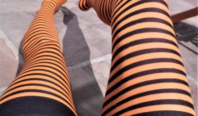 May More wearing black and orange striped stockings (top view of legs) - Masturbation Monday prompt for week 267